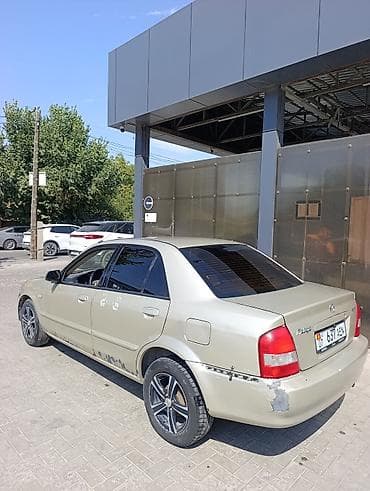 byd e7: Mazda 323: 2002 г., 1.6 л, Автомат, Бензин, Седан — 3
