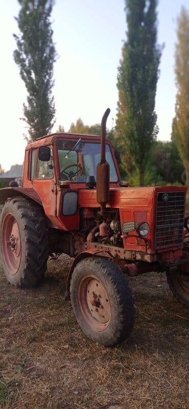 Тракторы ВТЗ: Красный трактор МТЗ, оснащенный кабиной для оператора, предназначен — 4