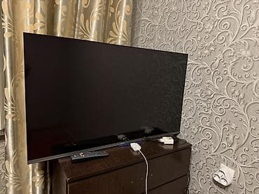 Телевизор LED (диагональ около 43–50"), тонкая рамка и узкий профиль