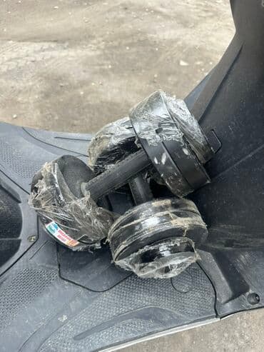 Пара разборных гантелей черного цвета. Диски зафиксированы на грифе с