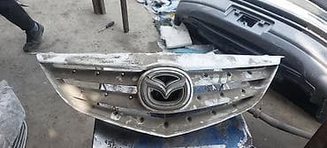 решетка на дверь: Решетка радиатора Mazda Оригинал — 9