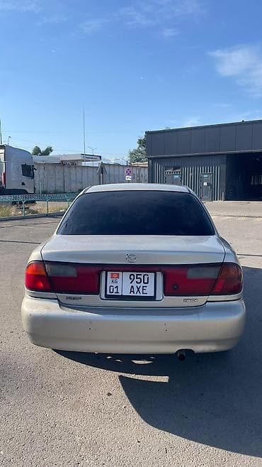 каропка автомат: Mazda 323: 1999 г., 1.5 л, Автомат, Газ, Седан — 6