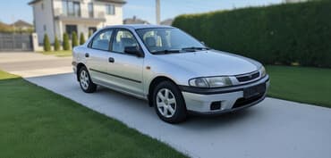 купить запчасти на опель вектра б: Mazda 323: 1998 г., Бензиновая, Седан — 1