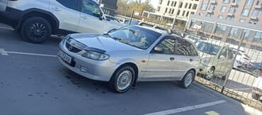 чехол на демио: Mazda 323: 2001 г., 1.3 л, Механика, Бензин, Хэтчбэк — 1