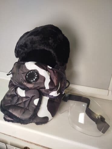 Зимняя шапка-ушанка с комплектом защиты лица маска+очки+шапка на фото