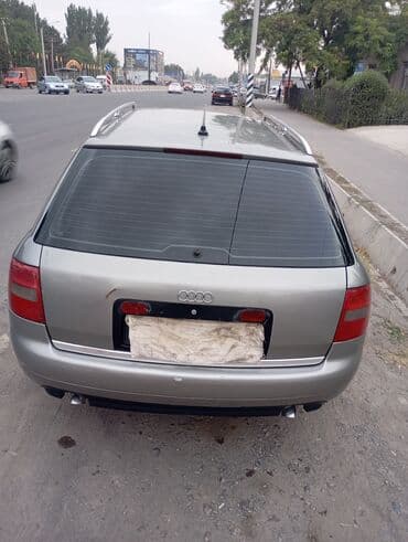 Универсал Audi A6 Avant C5 серого цвета, оборудованный рейлингами на