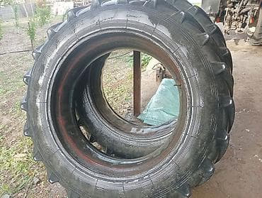 Шиналар жана дисктер: Пара сельскохозяйственных шин с выраженным елочным протектором. Задние — 7