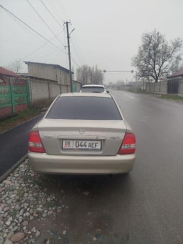 Транспорт: Mazda 323: 2001 г., 1.6 л, Кол менен иштөөчү, Бензин, Седан — 4