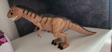 игрушки динозавра: Динозавр на батарейках, рычитходит, глаза горят. Рвботает от барейки — 2