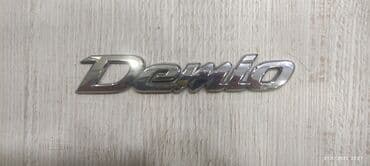 Шильдик мазда демио