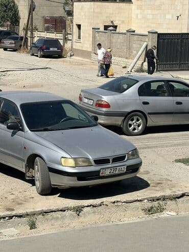 горный мотоцикл: Toyota Carina E: 1996 г., 1.8 л, Механика, Бензиновая, Седан — 1