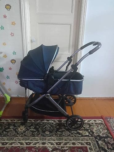 Детская коляска-люлька синего цвета. Особенности: - Универсальная