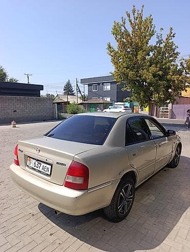 byd e7: Mazda 323: 2002 г., 1.6 л, Автомат, Бензин, Седан — 2