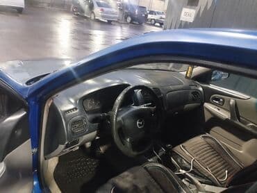 авто пулт: Mazda 323: 2001 г., Бензин, Хэтчбэк — 5