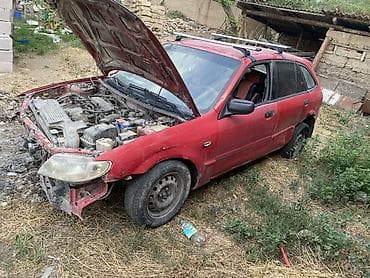 Скупка авто: Mazda 323 F (BA) универсал, красный цвет, левый руль. Атмосферный — 1