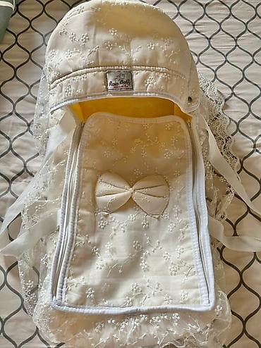 пошив верхней одежды: Детский конверт-кокон нежного молочного цвета от Rain Baby. Украшен — 1