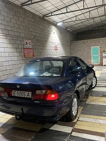 люки крыши: Mazda 323: 1997 г., 1.5 л, Автомат, Бензин, Седан — 6