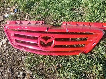 Решетки радиатора: Решетка радиатора Mazda Оригинал — 1