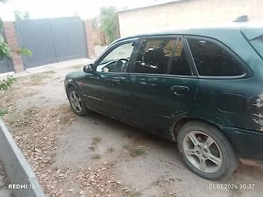 e 303: Mazda Familia: 2003 г., Универсал — 3