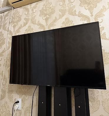 yasin 55q90: Телевизор NISIN, диагональ примерно 43–50". Тонкие рамки, плоская — 2