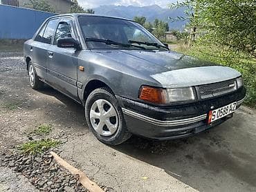 авто жак: Mazda 323: 1989 г., Кол менен иштөөчү, Бензин, Седан — 4