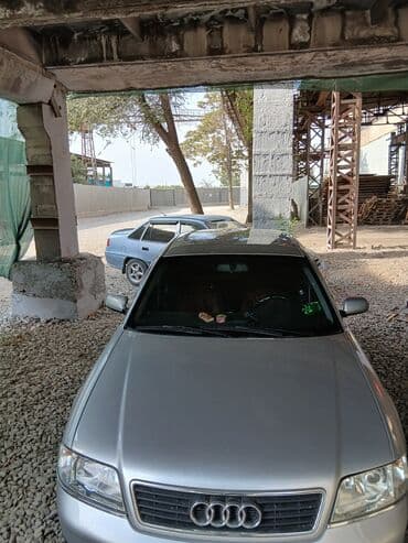 домкрат на ауди: Автомобиль Audi A6 серебристого цвета, представленный в кузове седан — 4