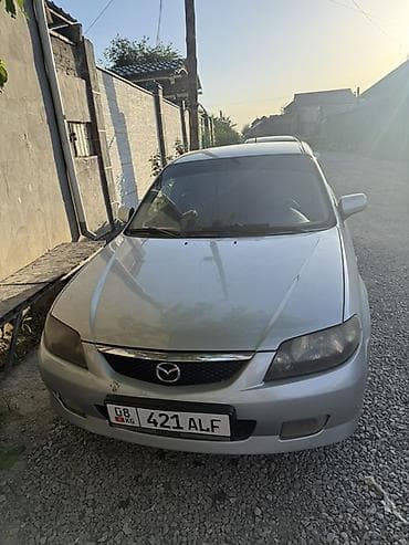 колонка microlab: Mazda 323: 2002 г., 1.6 л, Механика, Бензин, Универсал — 1