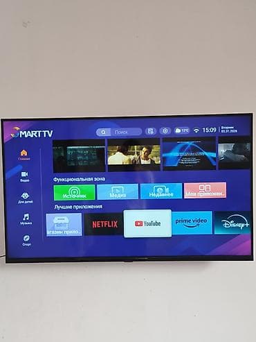 Смарт-телевизор с тонкими рамками и настенным креплением. На экране at lalafo.kg Смарт-телевизор с тонкими рамками и настенным креплением. На экране
