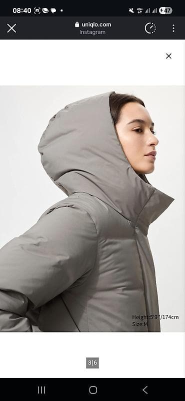 Удлиненная женская куртка-пуховик серого цвета с капюшоном at lalafo.kg Удлиненная женская куртка-пуховик серого цвета с капюшоном